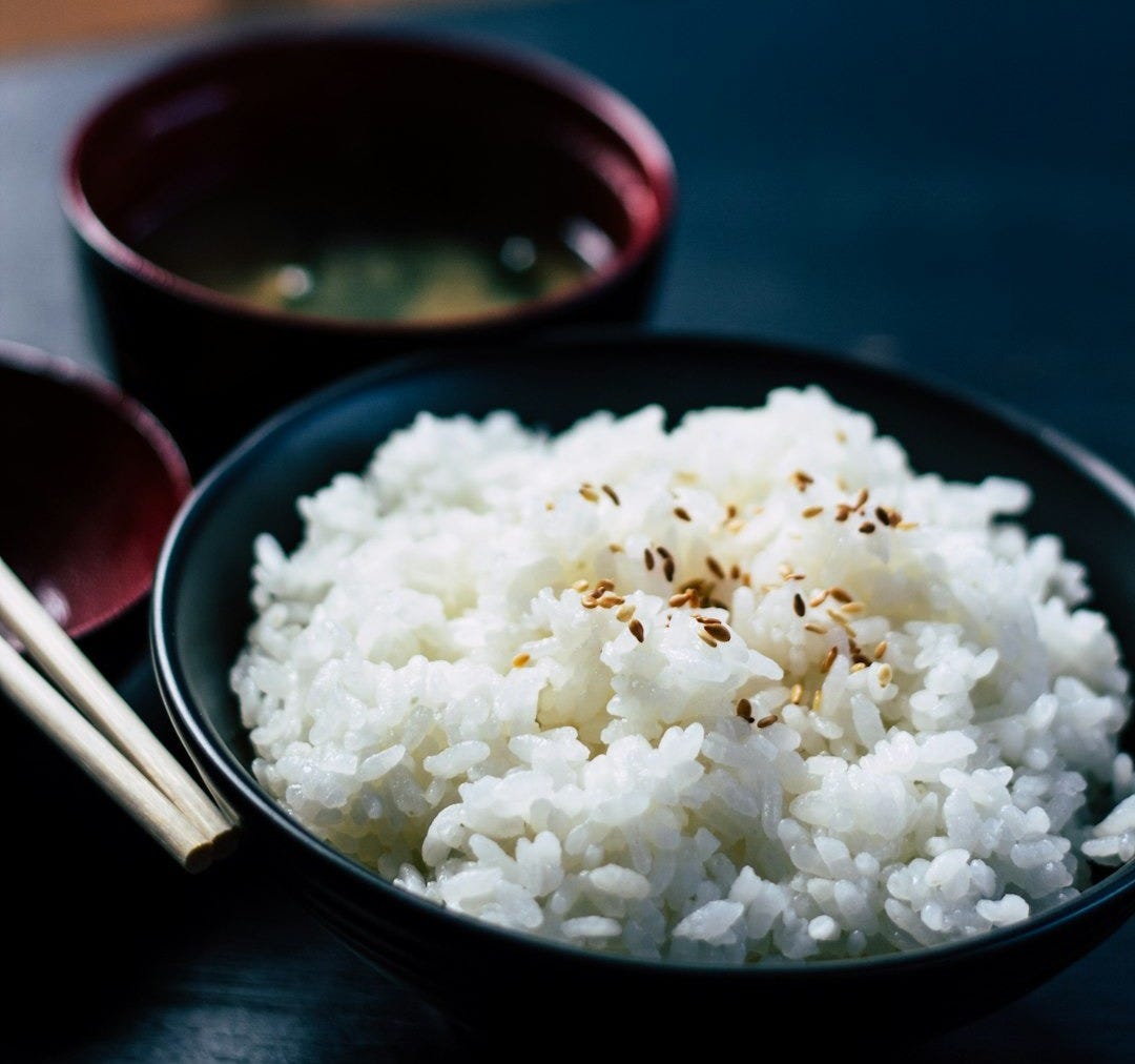 rice with sesame in black bowl