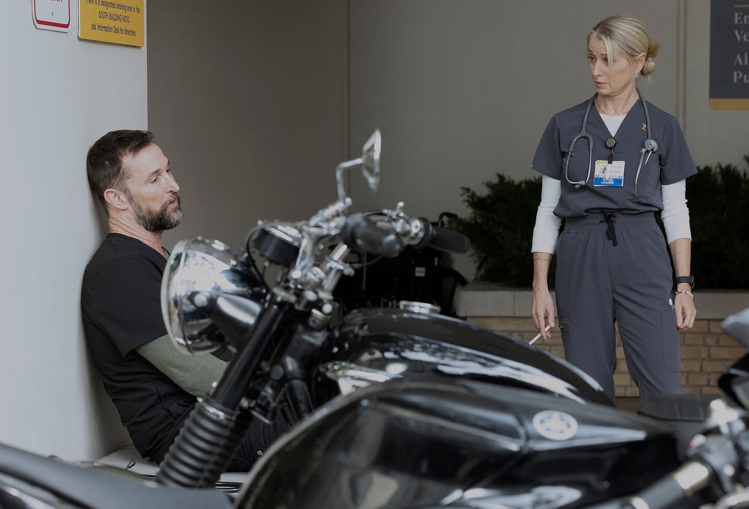 Two medical professionals talking outside an ED