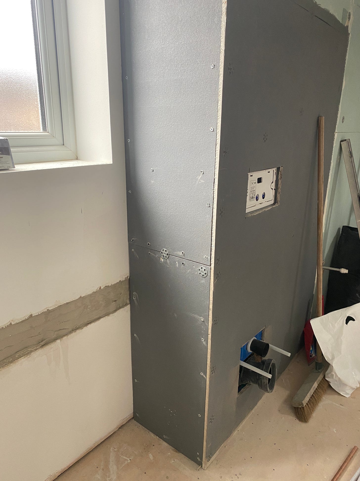 boxing-in covered with plasterboard in preparation for the toilet