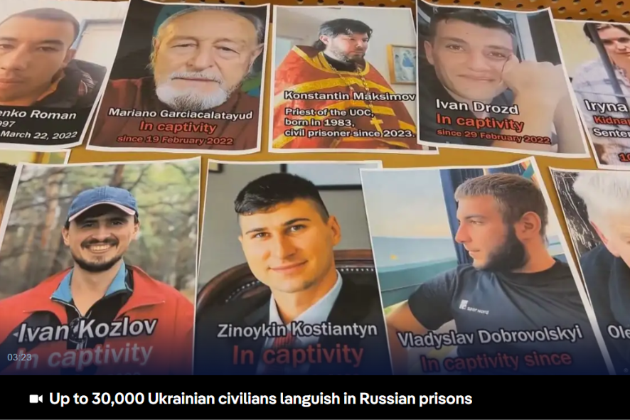 Photographs and names of missing Ukrainian civilians displayed on a table