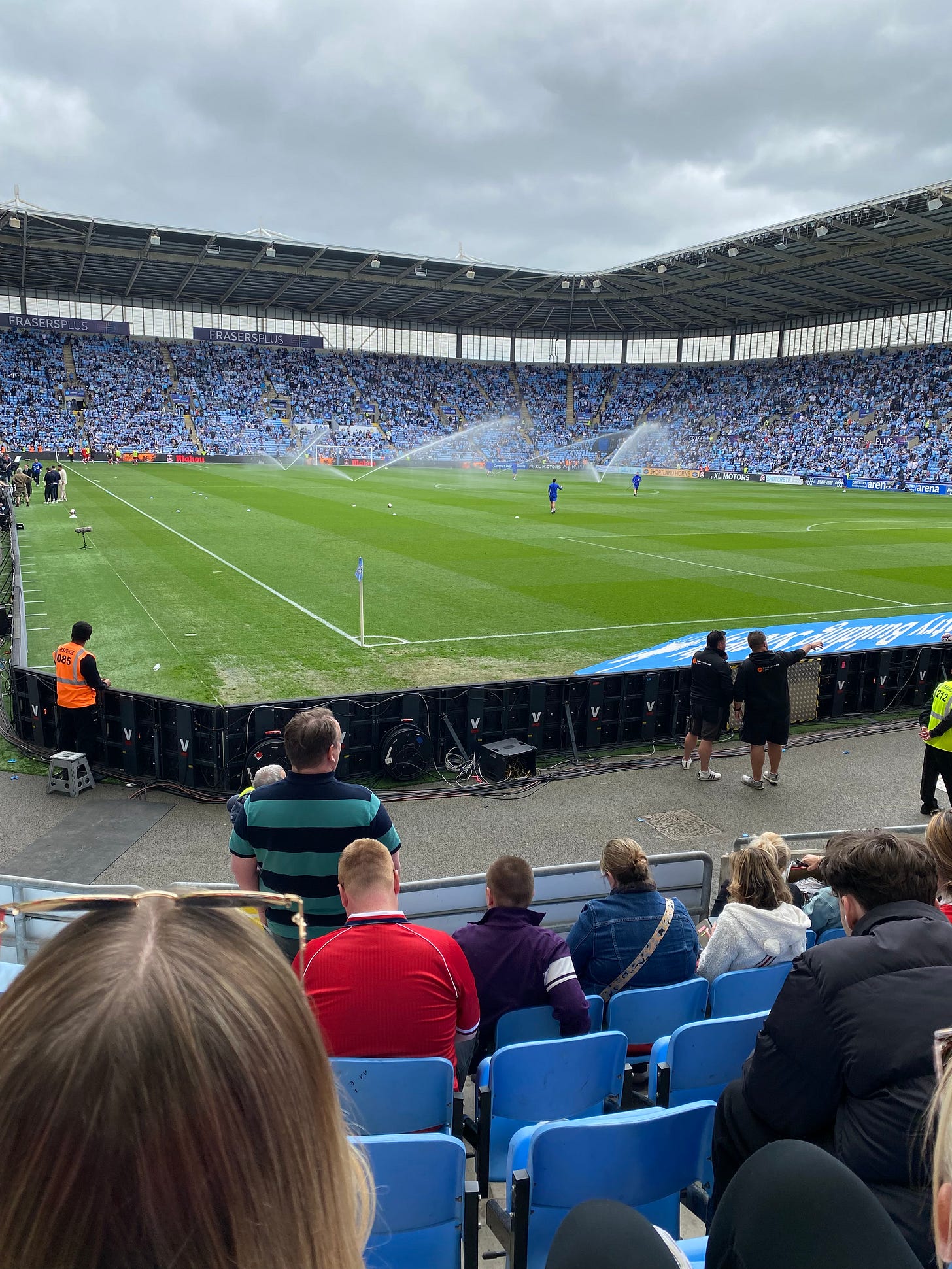 Coventry's stadium. It's difficult to tell whether the sky blue at the other end of the pitch is seats or people in football shirts. The sky, ironically, is not blue.