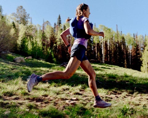 a woman running on a grassy trail a woman running on a grassy trail