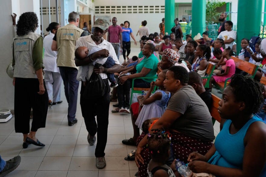 Parents with their children wait for medical attention at La Paix University Hospital 