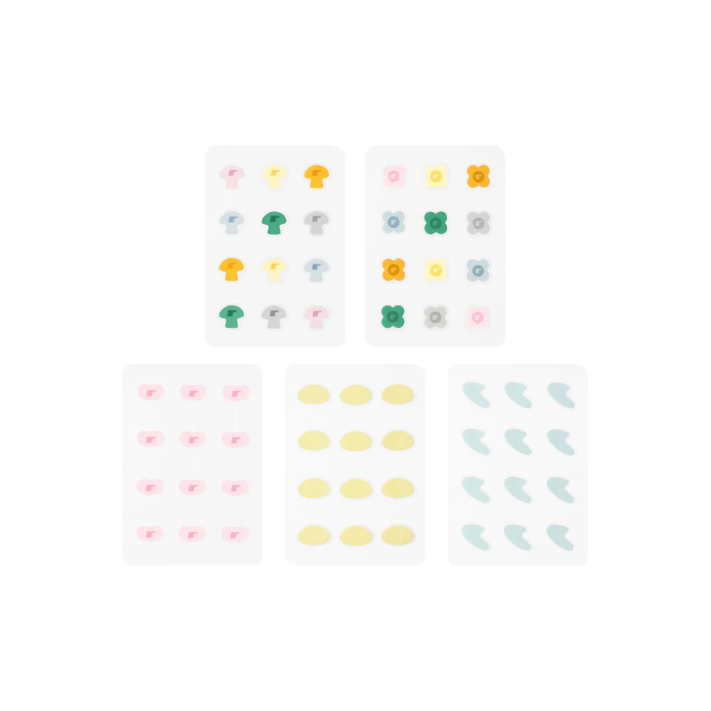 A product layout of the Rhode x The Biebers Spotwear collection, showing five sheets of decorative hydrocolloid pimple patches in the limited-edition shapes: colorful mushrooms, daisies, pink bubbles, yellow jelly beans, and blue curves. A product layout of the Rhode x The Biebers Spotwear collection, showing five sheets of decorative hydrocolloid pimple patches in the limited-edition shapes: colorful mushrooms, daisies, pink bubbles, yellow jelly beans, and blue curves.