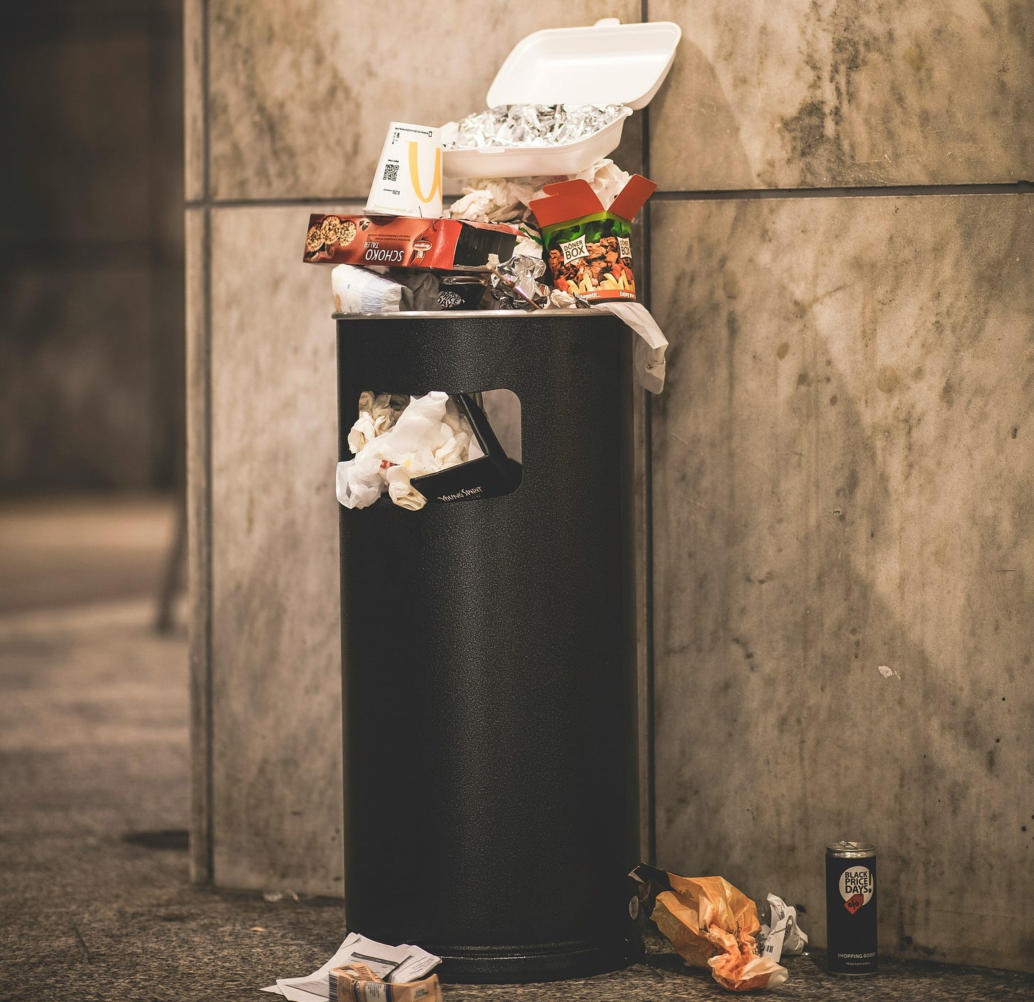 An overflowing garbage can to signify excessive waste