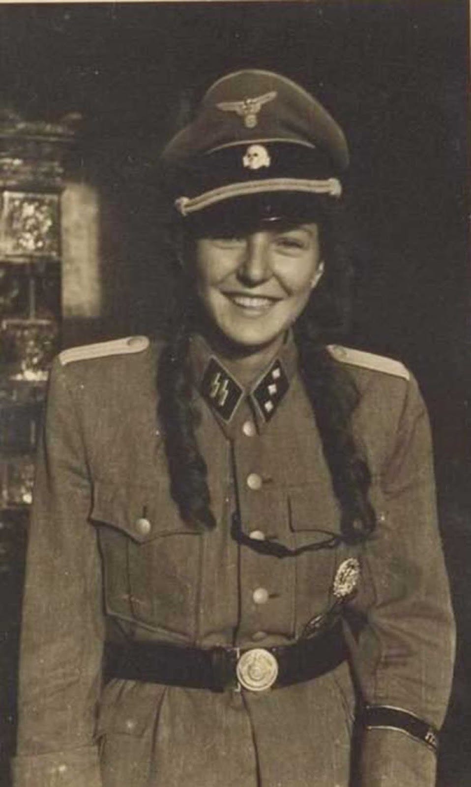 Another view of a woman involved with German forces, reflecting the complex social dynamics of the occupation. Another view of a woman involved with German forces, reflecting the complex social dynamics of the occupation.