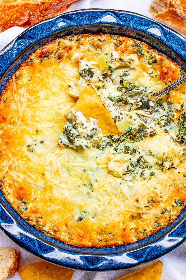Best Spinach Artichoke Dip in a bowl with a spoon sticking out. Best Spinach Artichoke Dip in a bowl with a spoon sticking out.