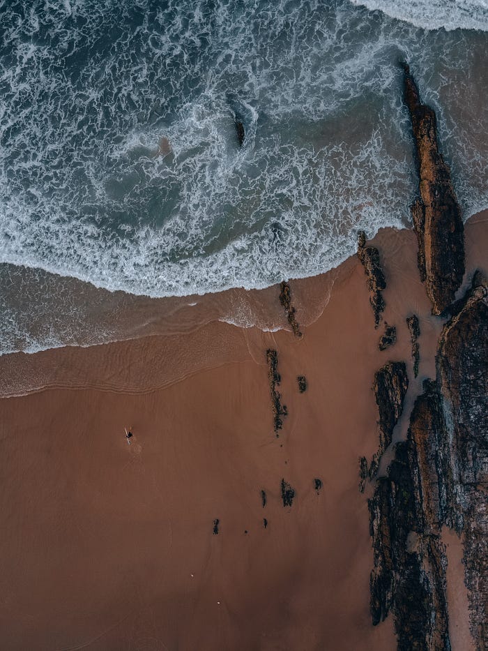 A bird’s eye view of a red sand beach in Oceania. A bird’s eye view of a red sand beach in Oceania.