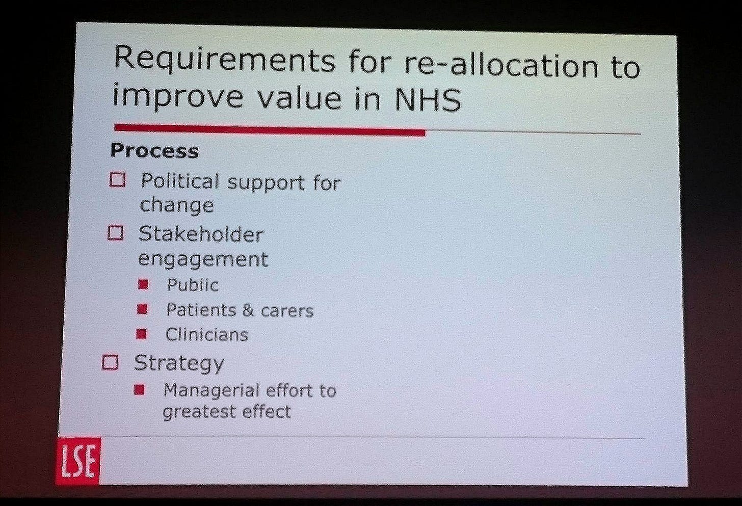 Slide titled “Requirements for re-allocation to improve value in NHS,” listing process factors: political support for change, stakeholder engagement with the public, patients and carers, and clinicians, plus strategy and managerial effort to greatest effect.
