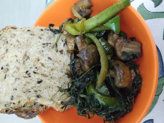 A orange bowl with slices of bread and vegetables. A orange bowl with slices of bread and vegetables.
