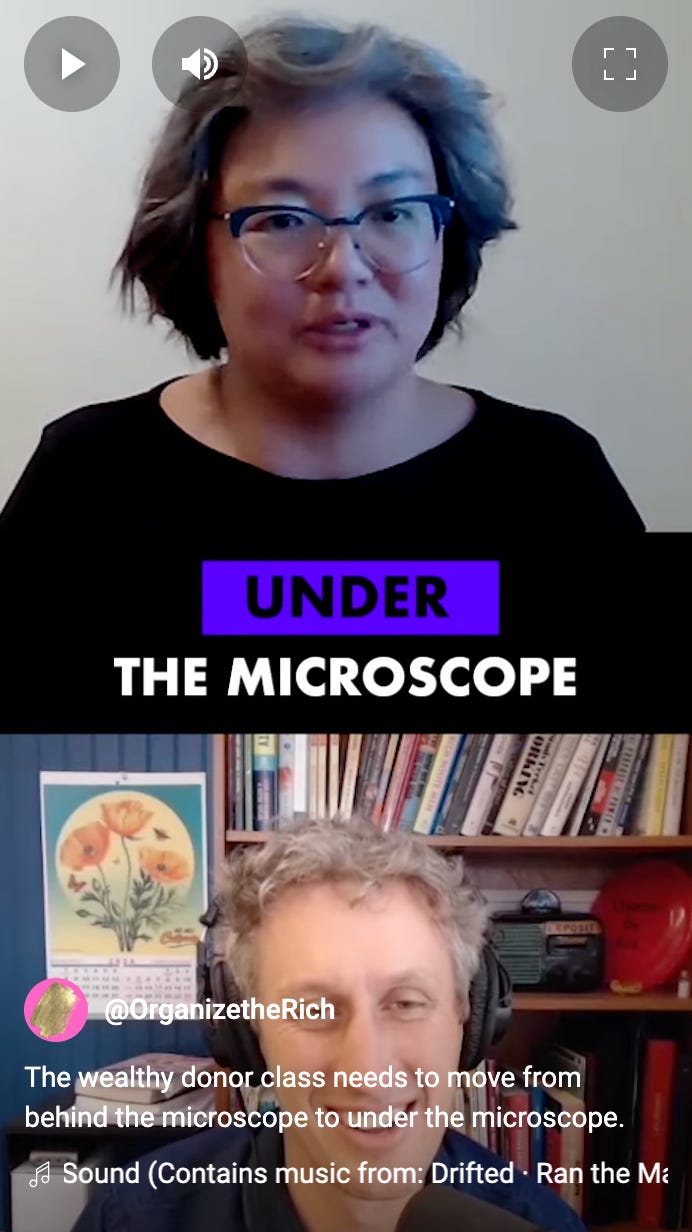Screenshot photo of Sharon talking with a grey background and a black shirt. The text says "Under the microscope in White and purple text.