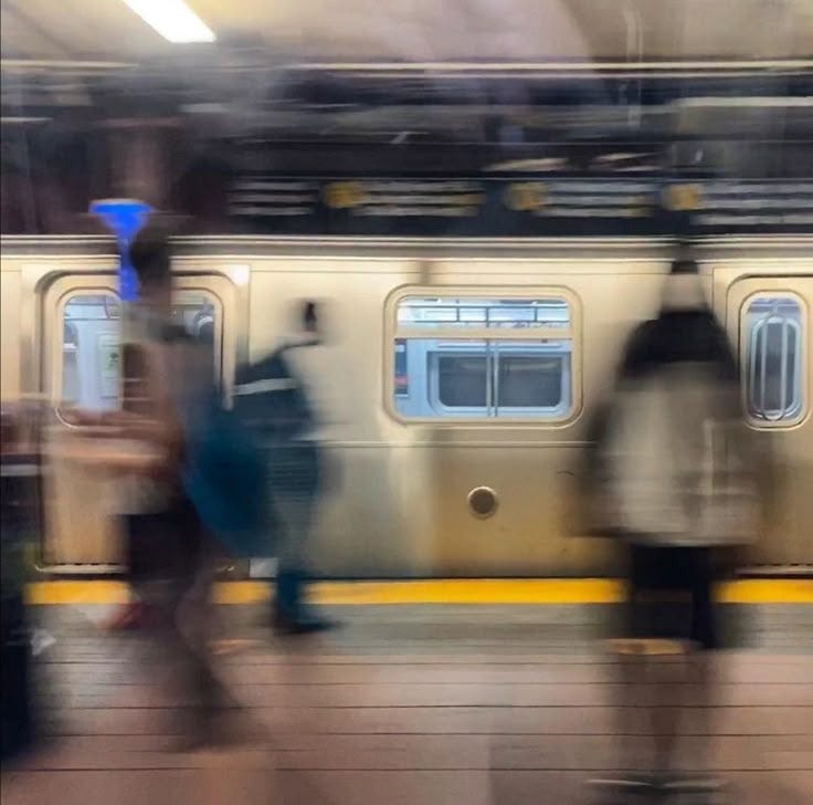 This may contain: blurry image of people walking in front of a train