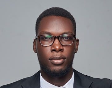 a man in a suit and glasses posing for a picture