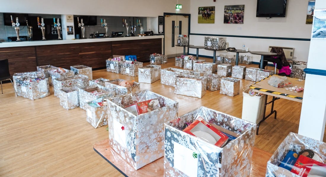 A hall with rows of silver boxes on the floor and on the tables