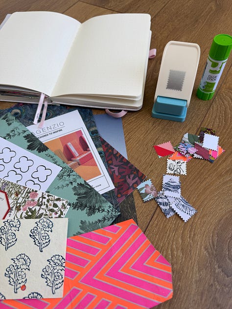 Open sketchbook, paper and magazine images, a hole punch and a glue stick