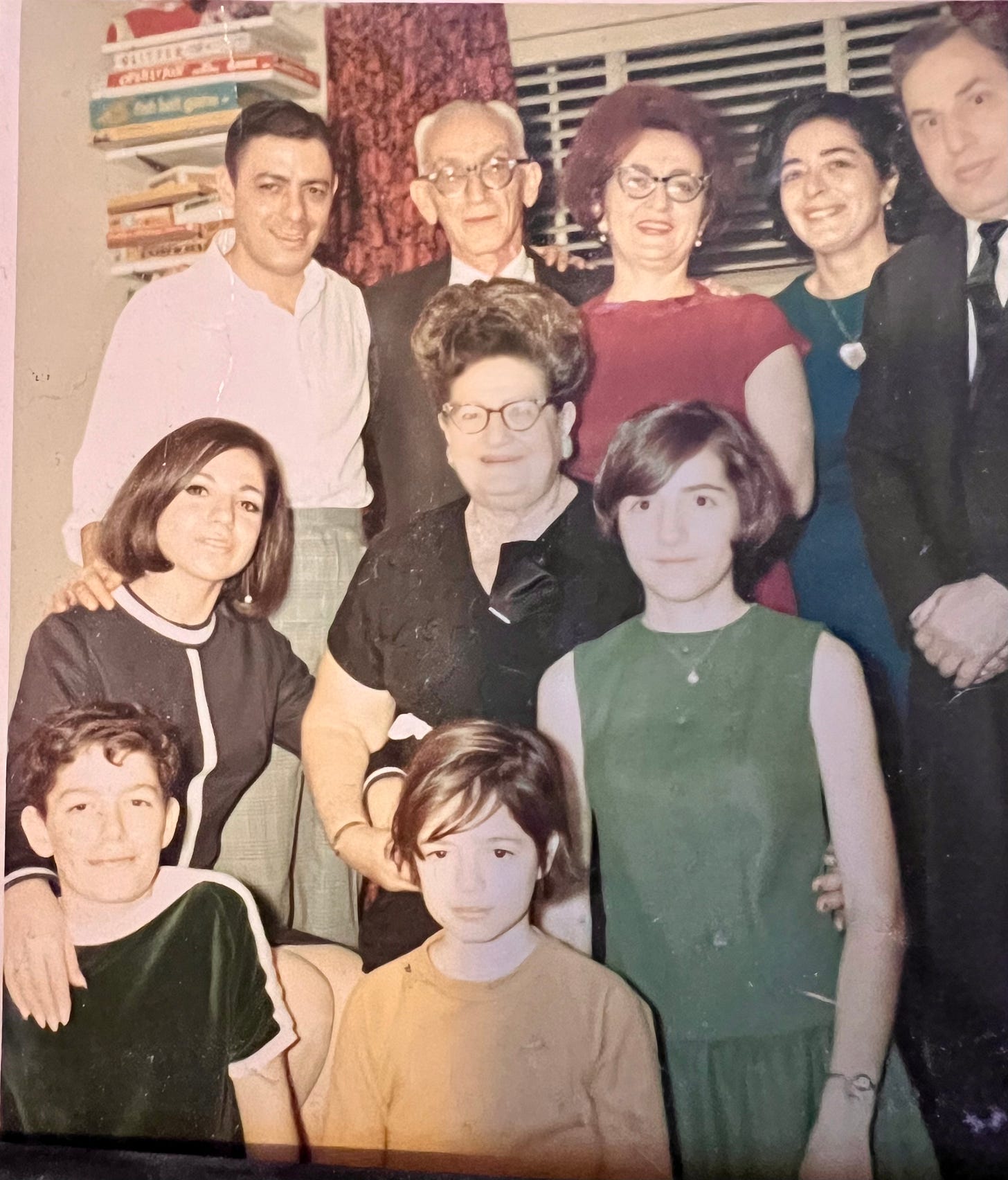 Family photo in my childhood bedroom: father, grandfather, aunt, mother, uncle,granother, two cousins, me and my broother