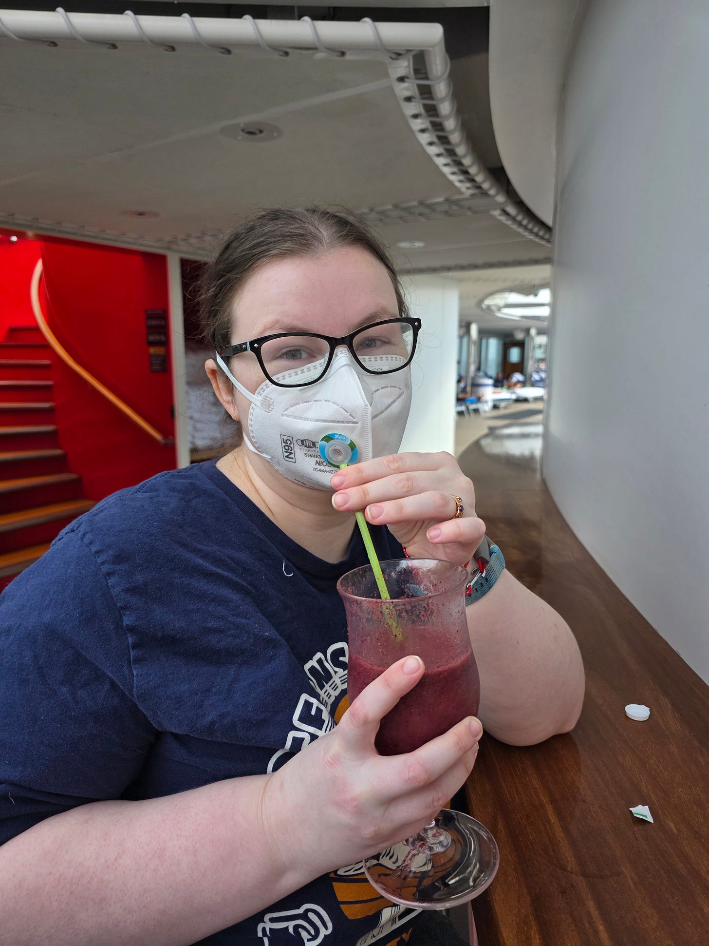 Me drinking a purple smoothie with acai at the juice bar on the pool deck while using my SIP valve