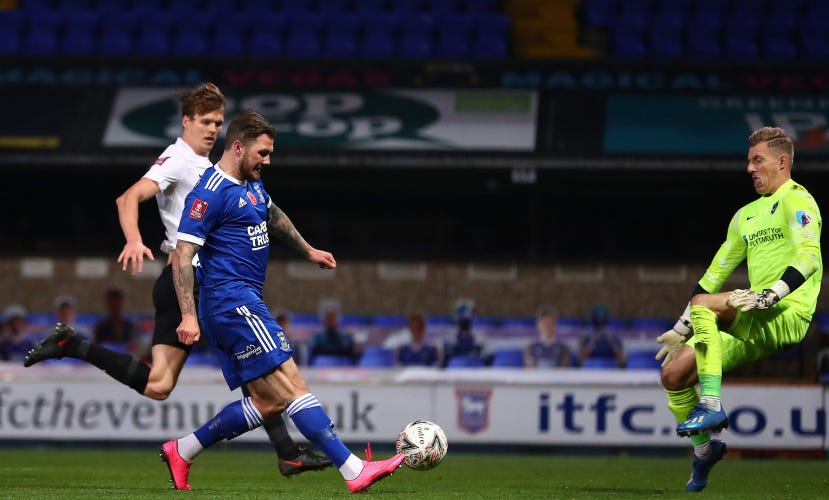 James Norwood scores Ipswich's second against Portsmouth in 2020 in front of the cardboard cut-out