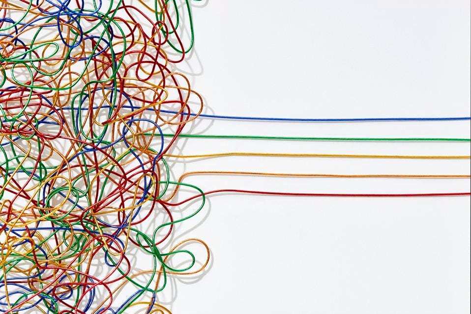 Jumble of multicoloured wires untangling into straight lines over a white background.