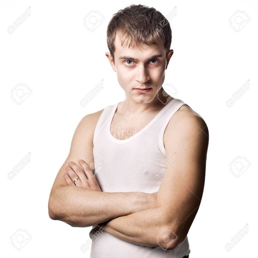 a young man with his arms crossed posing for the camera stock photo - 957982