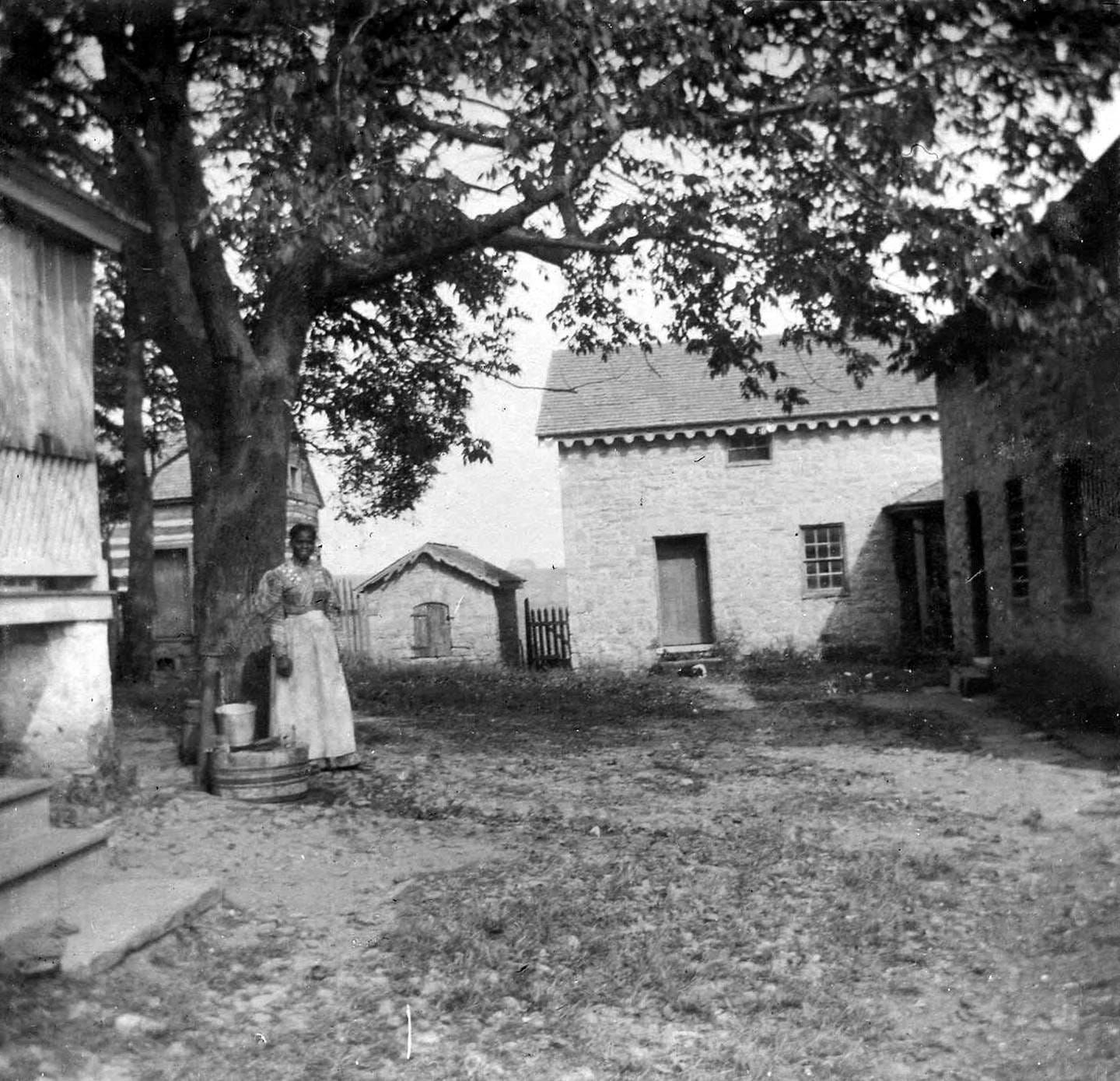The former quarters for the enslaved on Hampton plantation. The woman in the photo is likely Amanda Norris, 1897 The former quarters for the enslaved on Hampton plantation. The woman in the photo is likely Amanda Norris, 1897