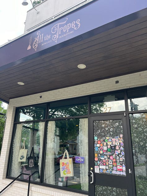 left: exterior of All the Tropes; center: interior with two fancy chairs and my book propped in between; right: Kate holding up a board with sentence strips on it while I look on