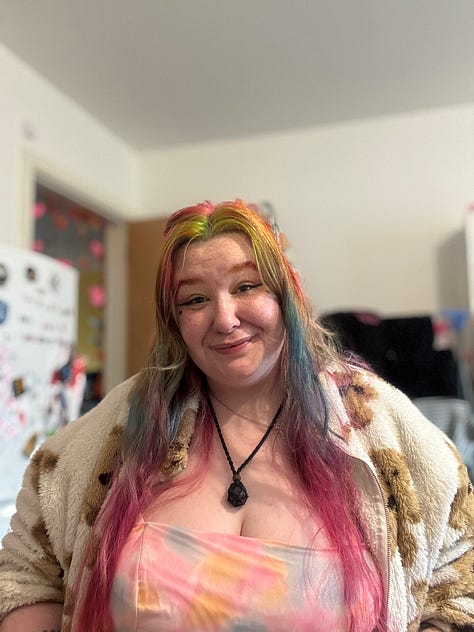photo 1: An infographic showing MCR Pathways statistics for 2025, including numbers of young people matched with mentors, regional breakdowns across the UK, mentor figures, and total volunteer hours contributed over recent years.  photo 2: A person smiling warmly at the camera indoors, with brightly coloured rainbow hair, green and pink makeup, and a soft patterned jacket. They are seated in a wheelchair that isn’t fully visible in the frame, with a cosy room and decorations in the background.  photo 3: The same person smiling and holding a fan of handwritten speech cue cards above their head. They are wearing a fluffy patterned jacket and have colourful hair, with part of a kitchen behind them.