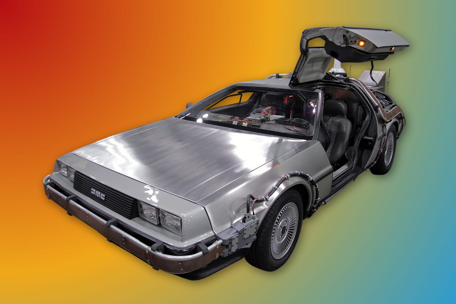 A silver DeLorean car with gull-wing doors open, displayed against a gradient orange to blue background. A silver DeLorean car with gull-wing doors open, displayed against a gradient orange to blue background.