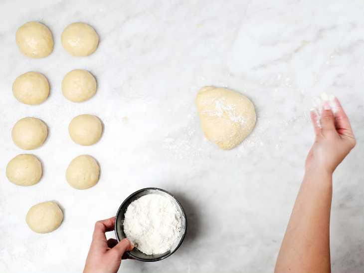 sprinkling dough ball with flour
