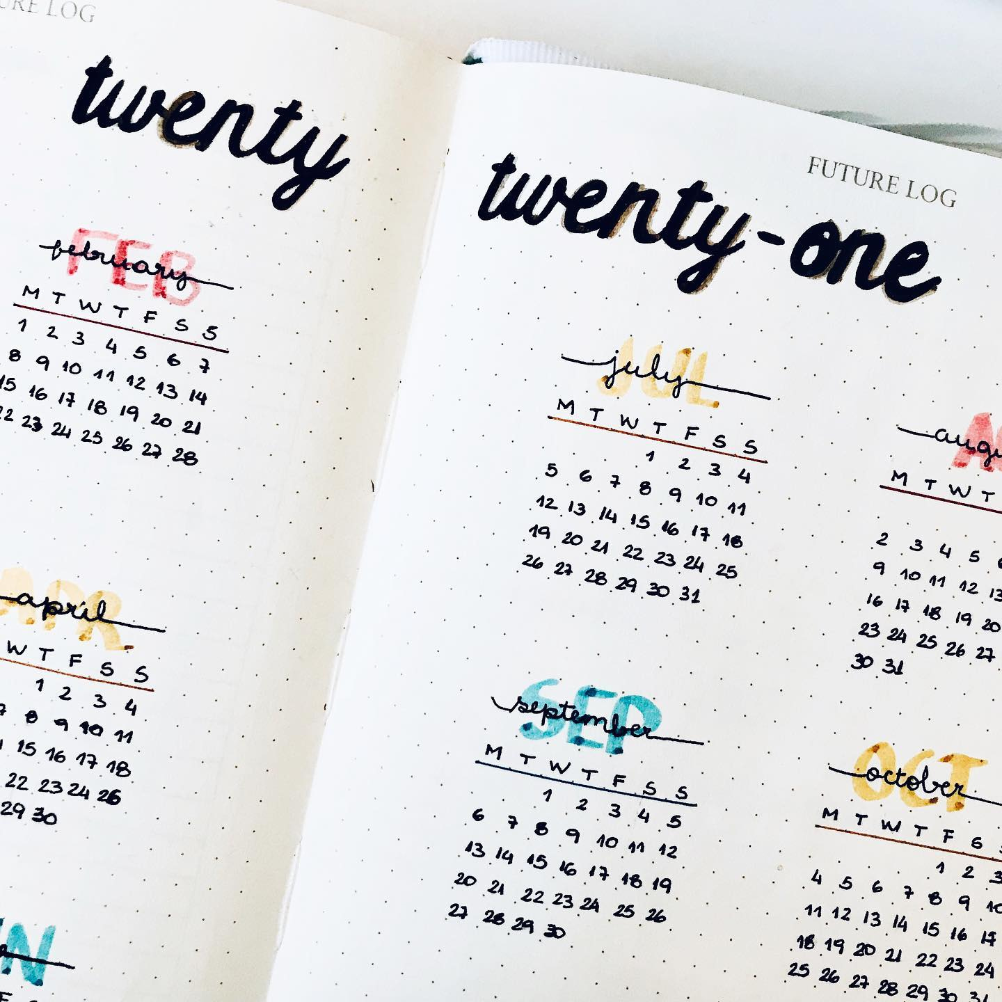 Photo of an open journal with a section of a handwritten calendar for 2021 Photo of an open journal with a section of a handwritten calendar for 2021
