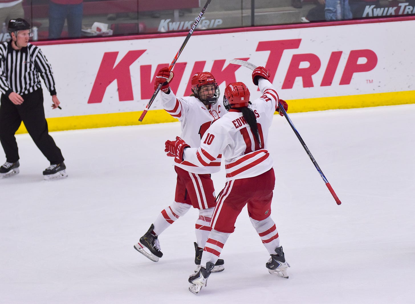 Caroline Harvey and Laila Edwards extend their arms out toward each other for a hug