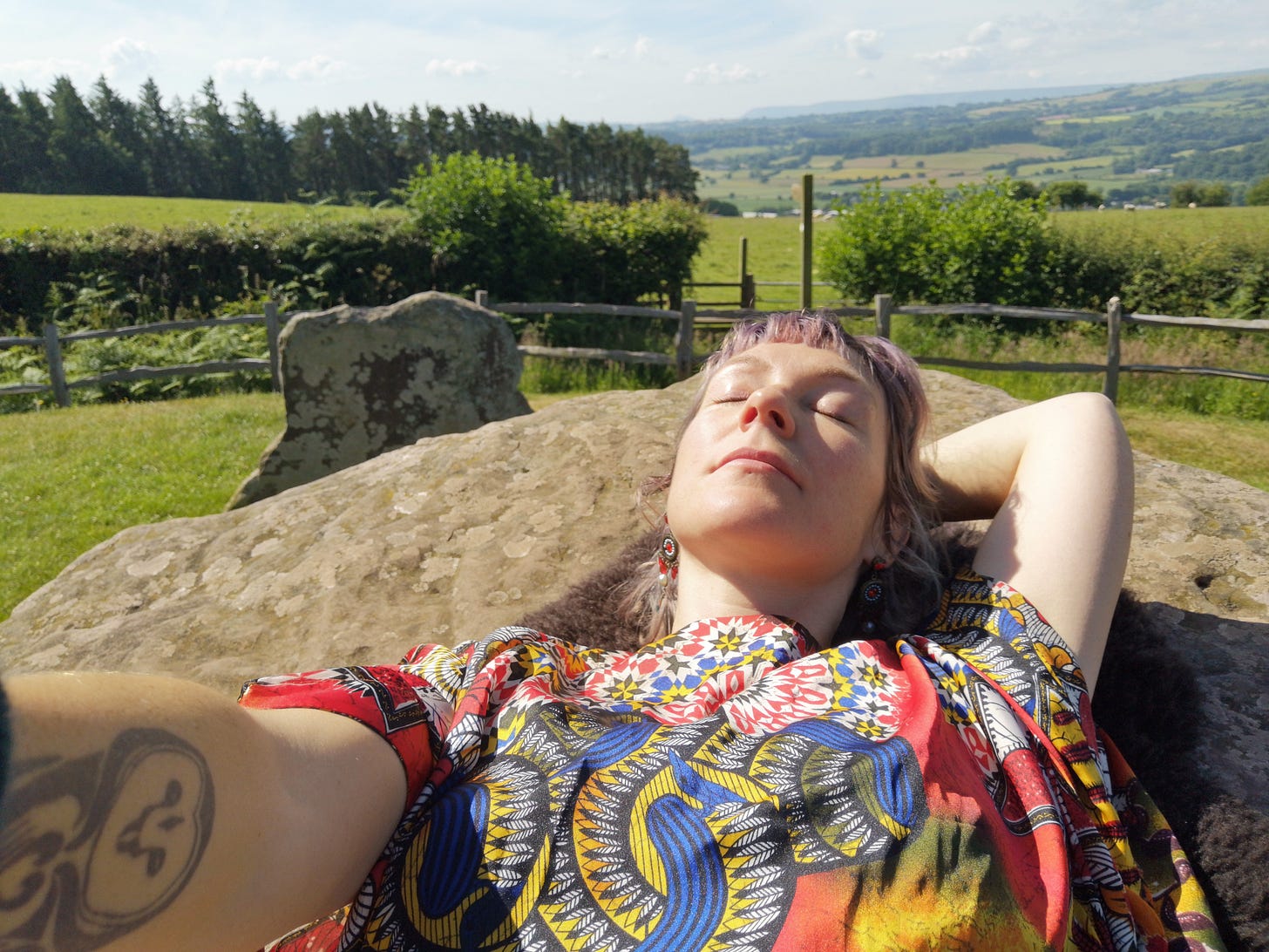 Layne lying on arthurs tombe with the sun on her face, relaxing