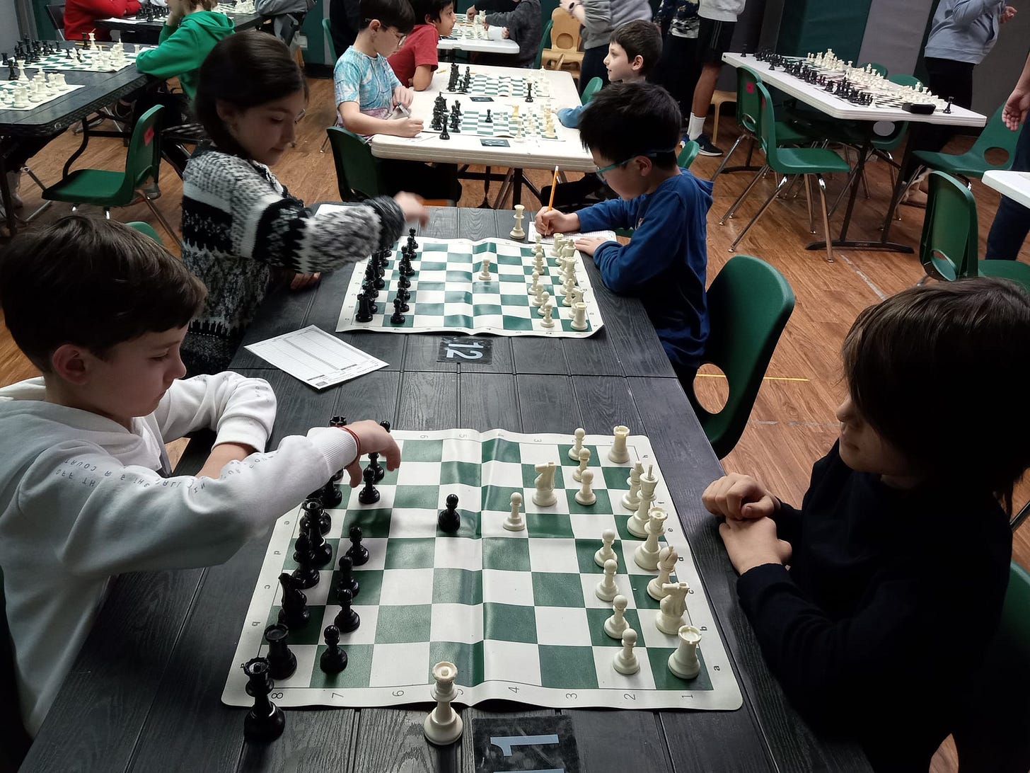 May be an image of 8 people and chess