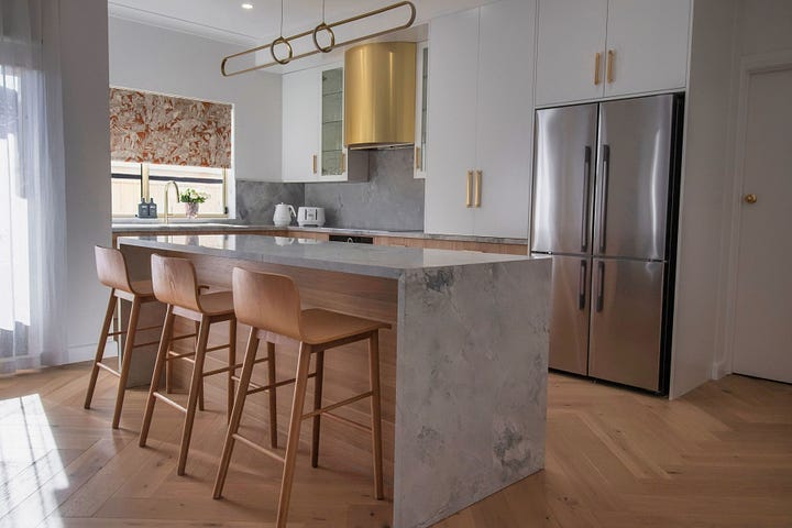 luxury resort-style kitchen in wood grain and super white quartzite designed by Plush Design Interiors and Penelope Herbert
