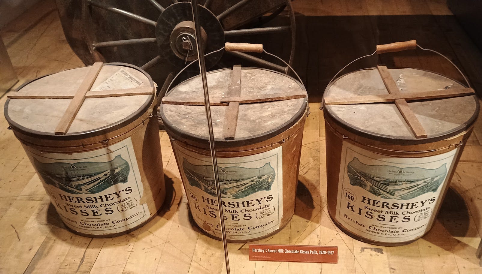 Three metal lidded tubs of Hershey's Kisses