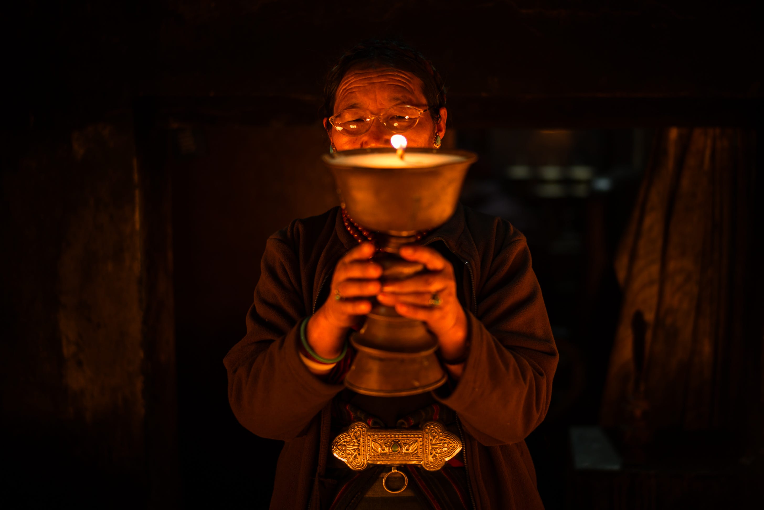 Making an offering, Boudha, Nepal. 1/90, ƒ/2, ISO 400, 50mm