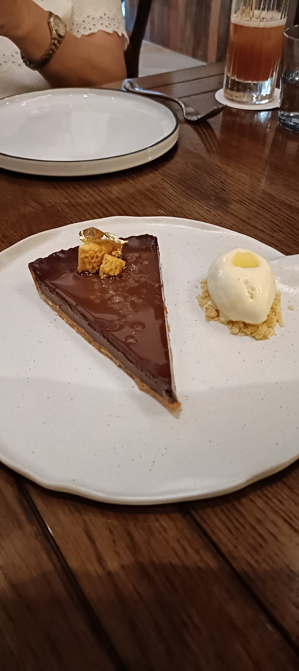 chocolate tart with a plate in the background