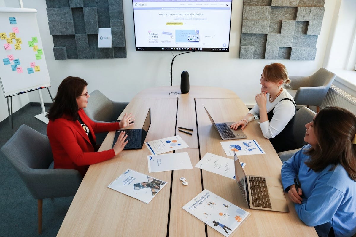 Strategic marketing team reviewing business transformation data on a screen in a modern conference room. Strategic marketing team reviewing business transformation data on a screen in a modern conference room.