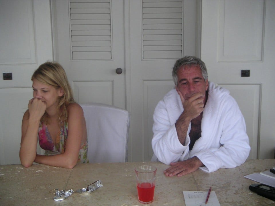 Epstein sat at a table wearing a dressing gown with Marcinkova