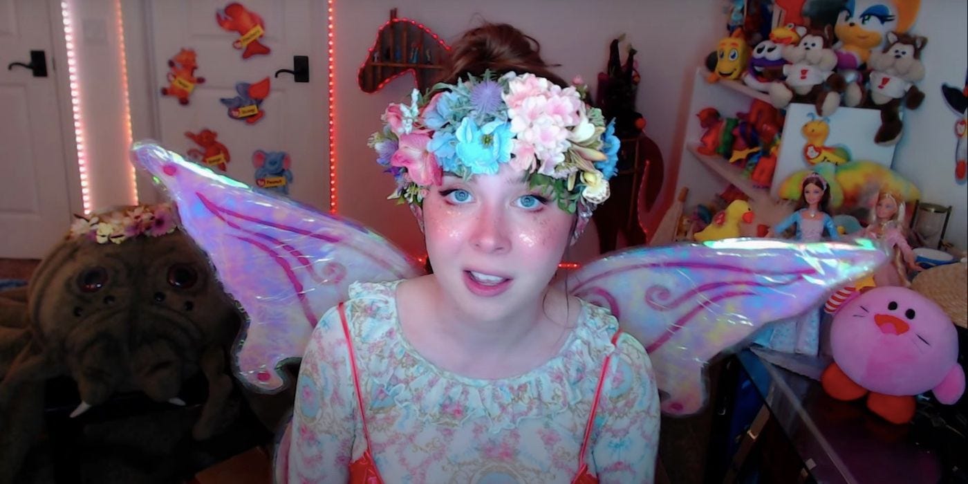 A screenshot of Jenny Nicholson from her video on Evermore Park, where she is talking directly into the camera while dressed as a fairy, complete with wings and a flower crown