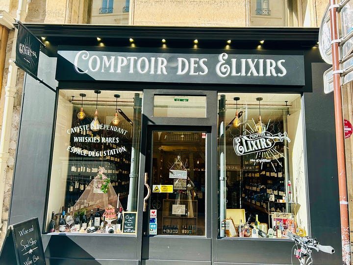 a wine shop and the owner on rue du Bac