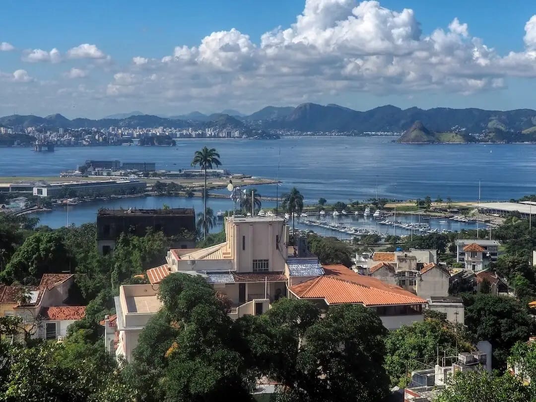 View of buildings, a bay and mountains in the background