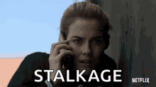 a woman talking on a cell phone with stalkage netflix written below her a woman talking on a cell phone with stalkage netflix written below her