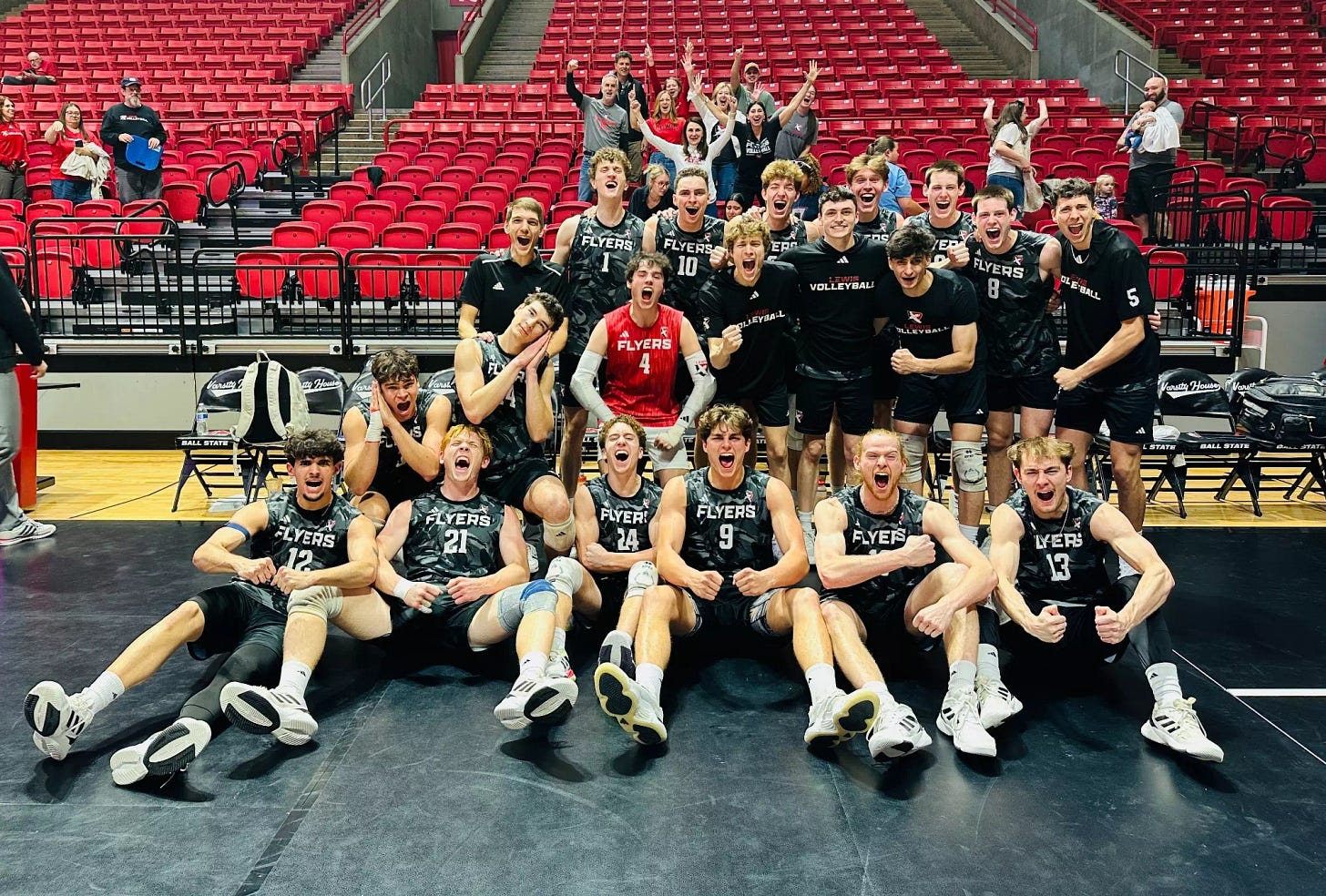 Men's volleyball celebrates a road win