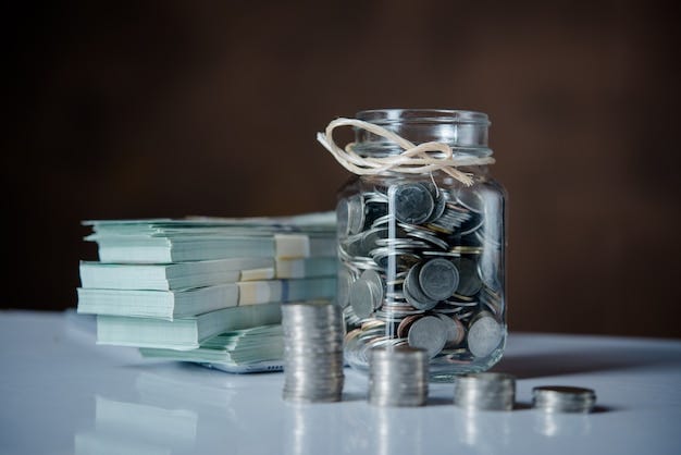 Free photo bottles of cash with coins  in saving money concept