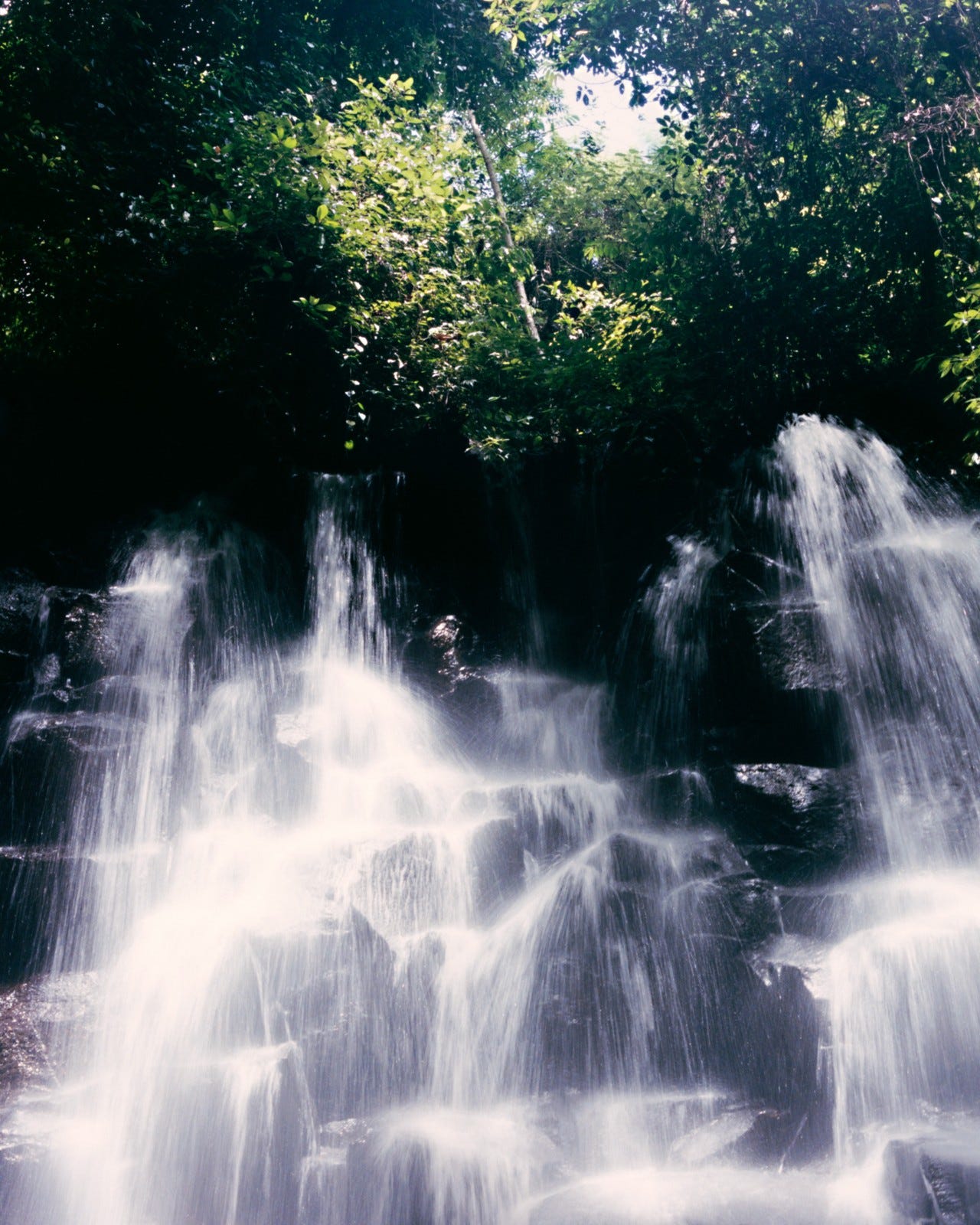 Water cascades over a stack of rocks.