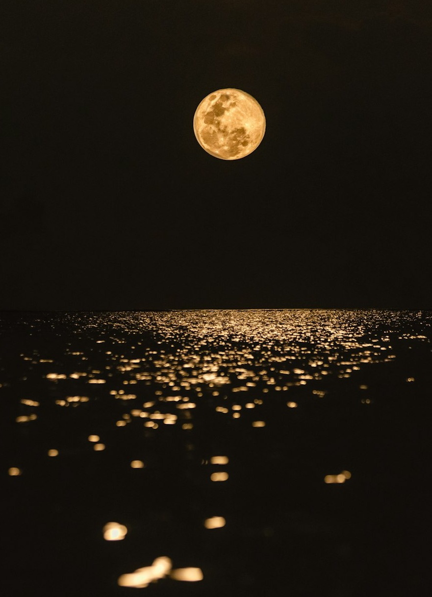 full moon over the body of water