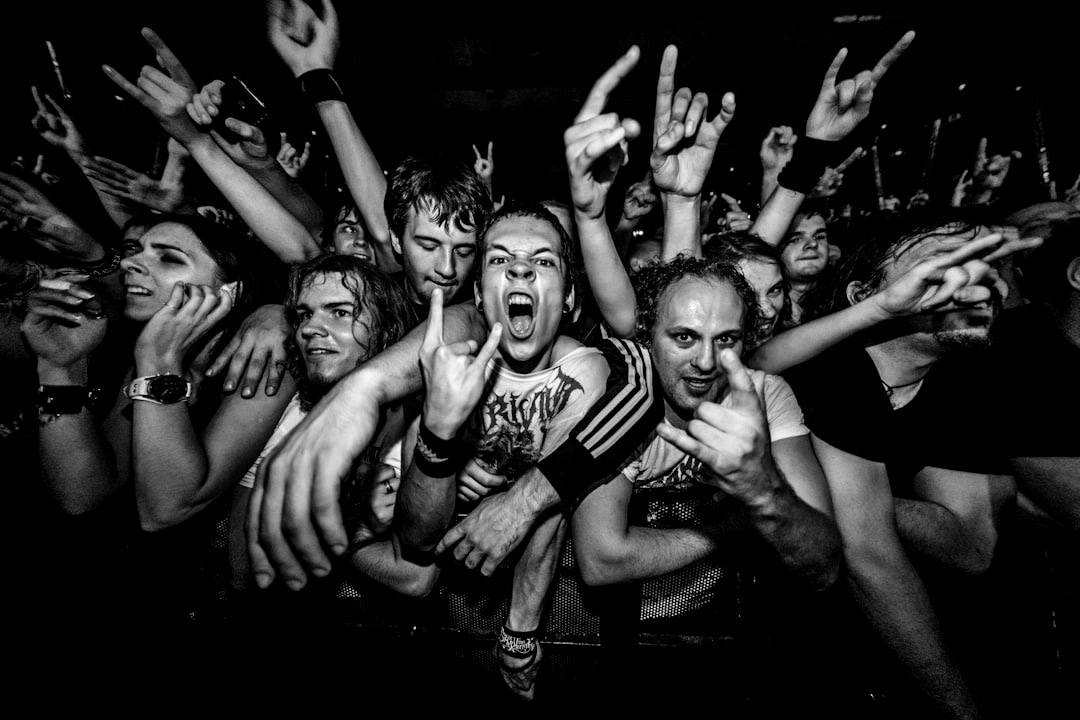 a crowd of people with their hands in the air