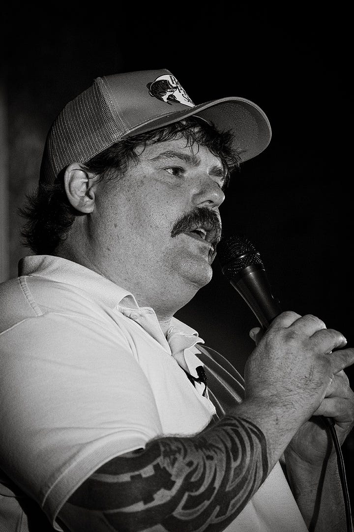 Mitch Burrow onstage at Liquid Laughs