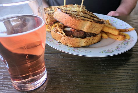 Wilson's shiny bar, sandwich and fries and strawberry cider, a can of sparkling apple cider
